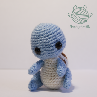 Front view of a Squirtle crochet plushie, made from light blue, light yellow, brown, and white yarn.